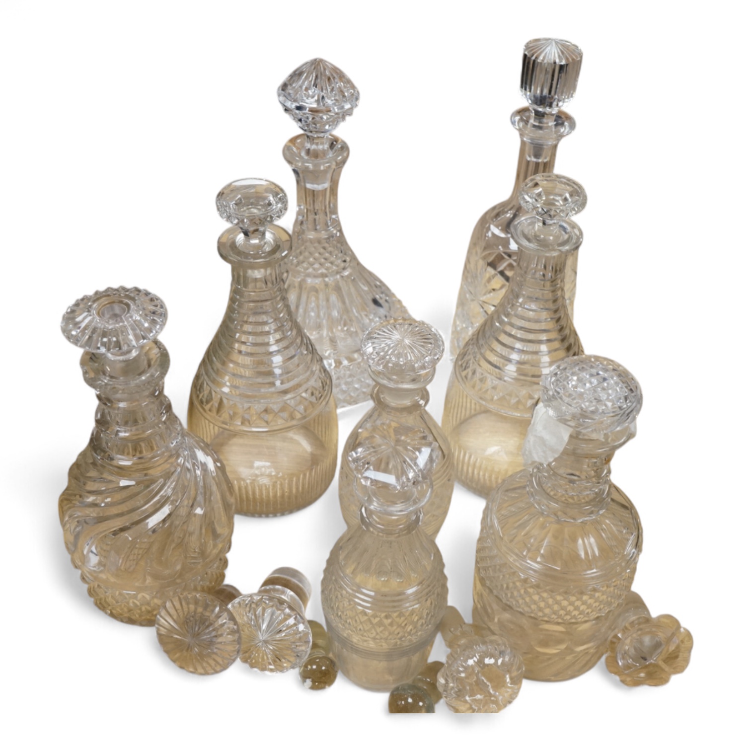 A collection of Regency and later glass decanters and stoppers, tallest 31cm